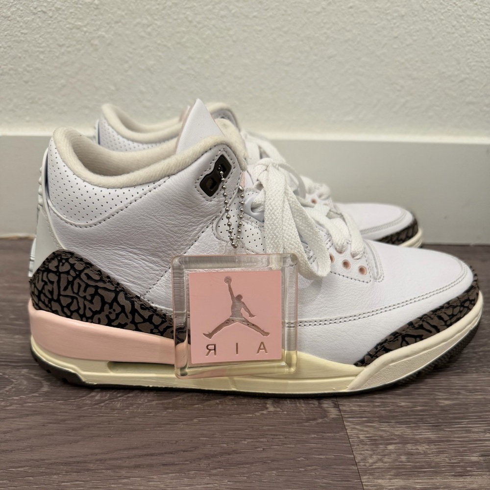 Women's White and Pink Air Jordan size 9 sneakers.